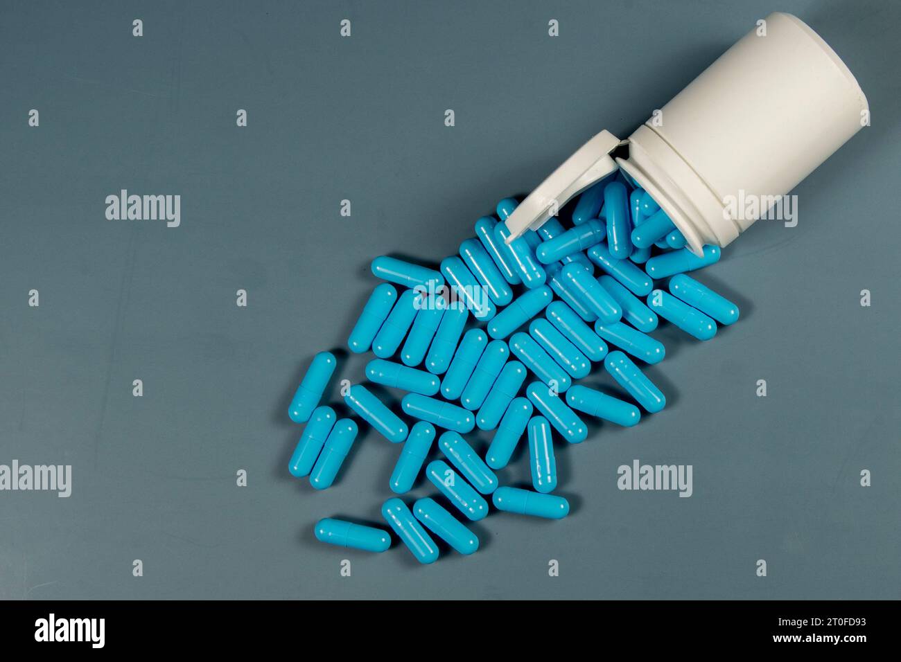 Gelatin pills sticking out of a white medicine bottle. Pharmaceutical