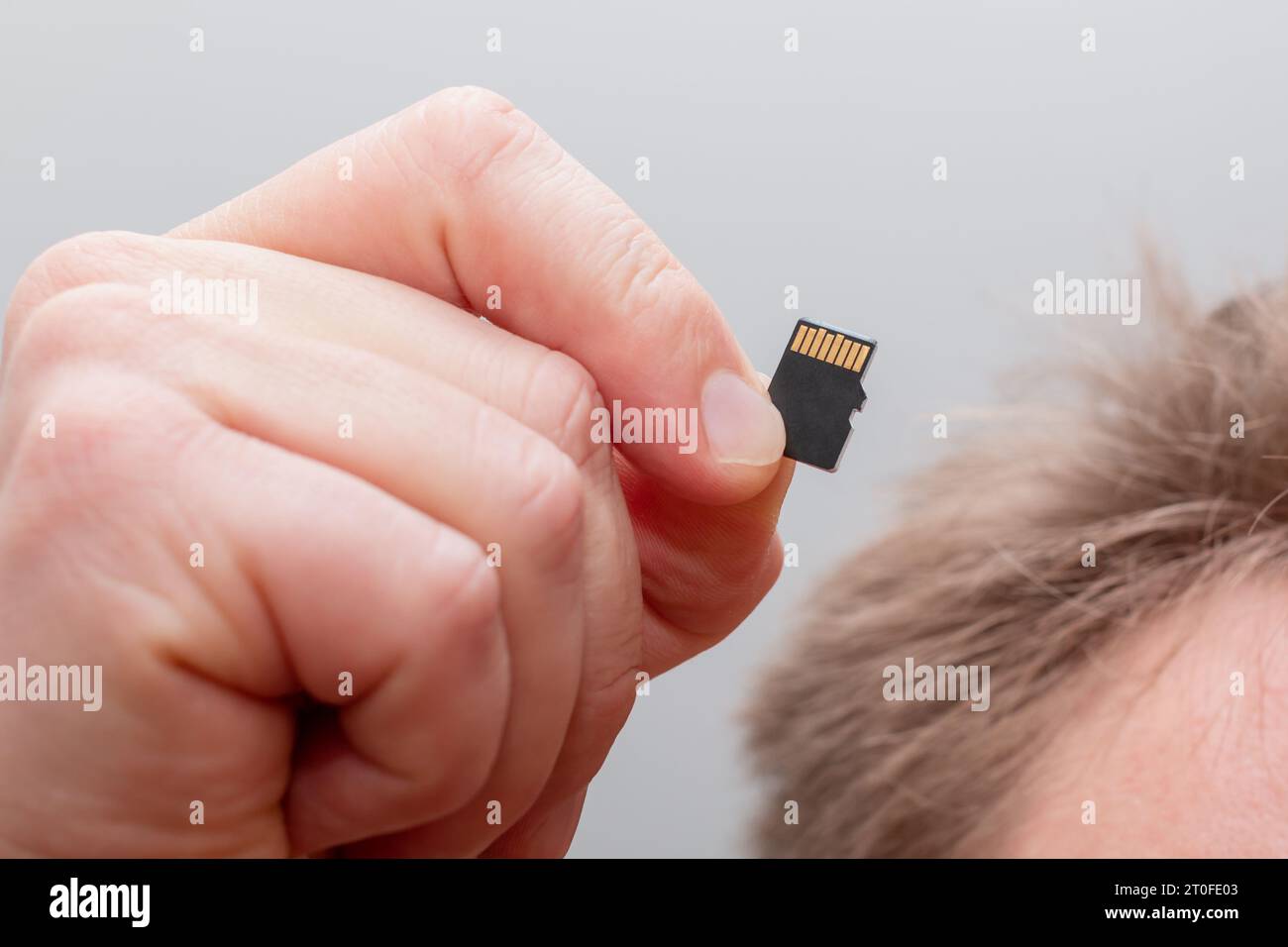 Holding micro SDHC card in a hand - shallow focus Stock Photo