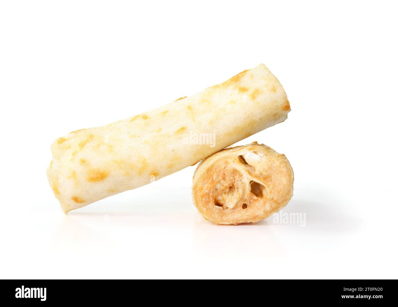 Isolated dog chew bone made without hide. Stack of baked and rolled ...