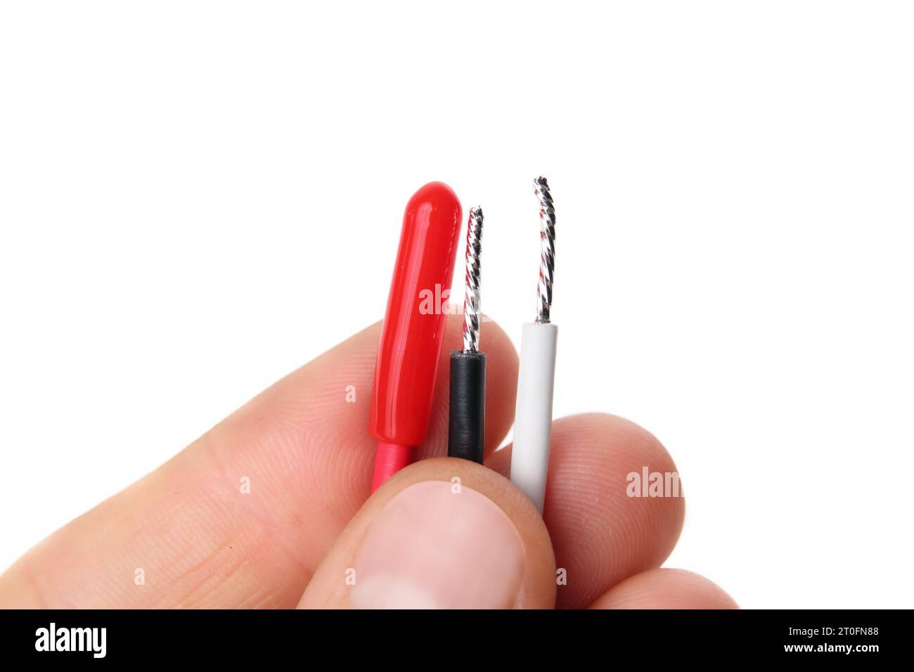Electrical wires in electrician hand. Red, black and neutral wires indicating hot wire