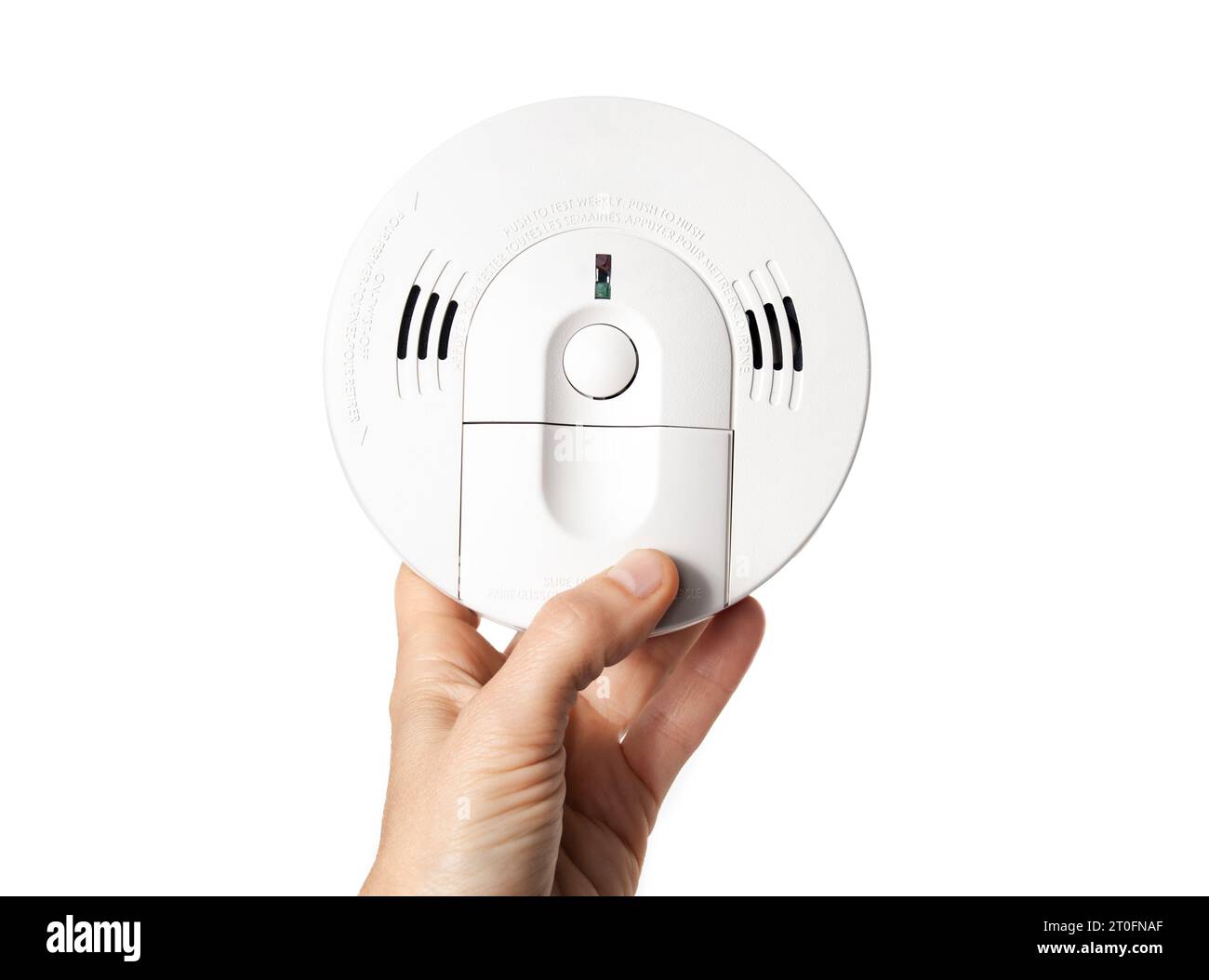 Smoke detector with carbon monoxide alarm in hand of homeowner or electrician. Hard wired with backup batterie. Fire safety product for homes, apartme Stock Photo