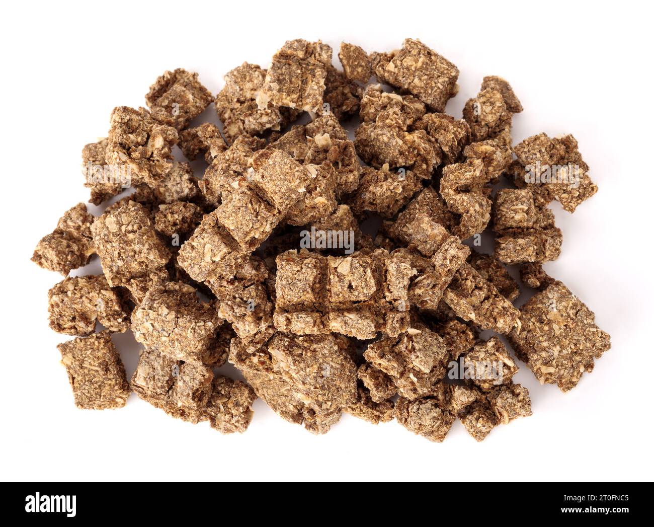 Top view of dried fish pieces for dogs and cats. Snack, treat or reward. Heap of dehydrated flaky fish chunks. Healthy dog snack or health supplement Stock Photo