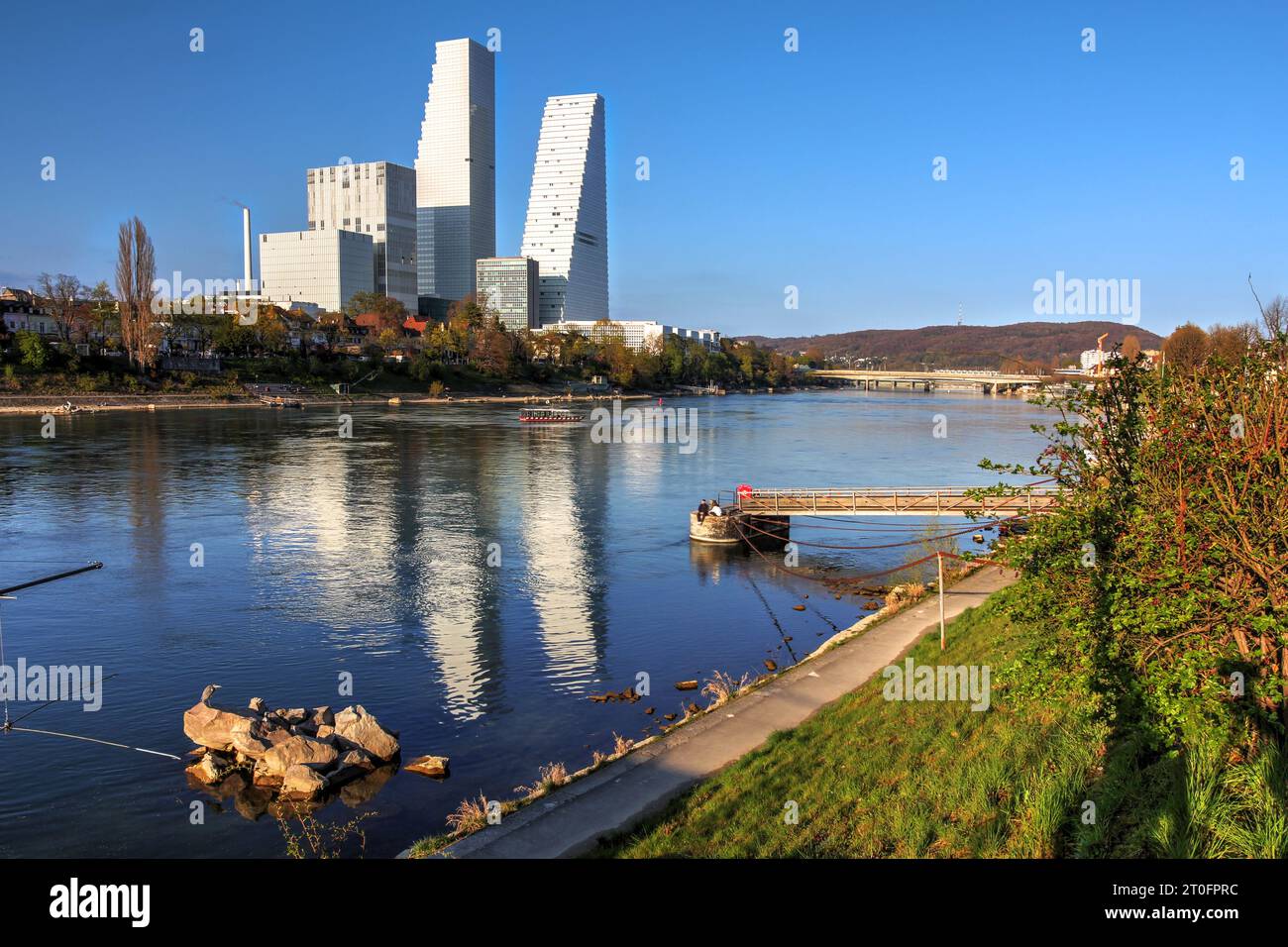 Skyline of Basel, Switzerland along the Rhine River, featuring the Roche Towers and biotech campus as of 2023. The taller skyscraper, finished in 2022 Stock Photo