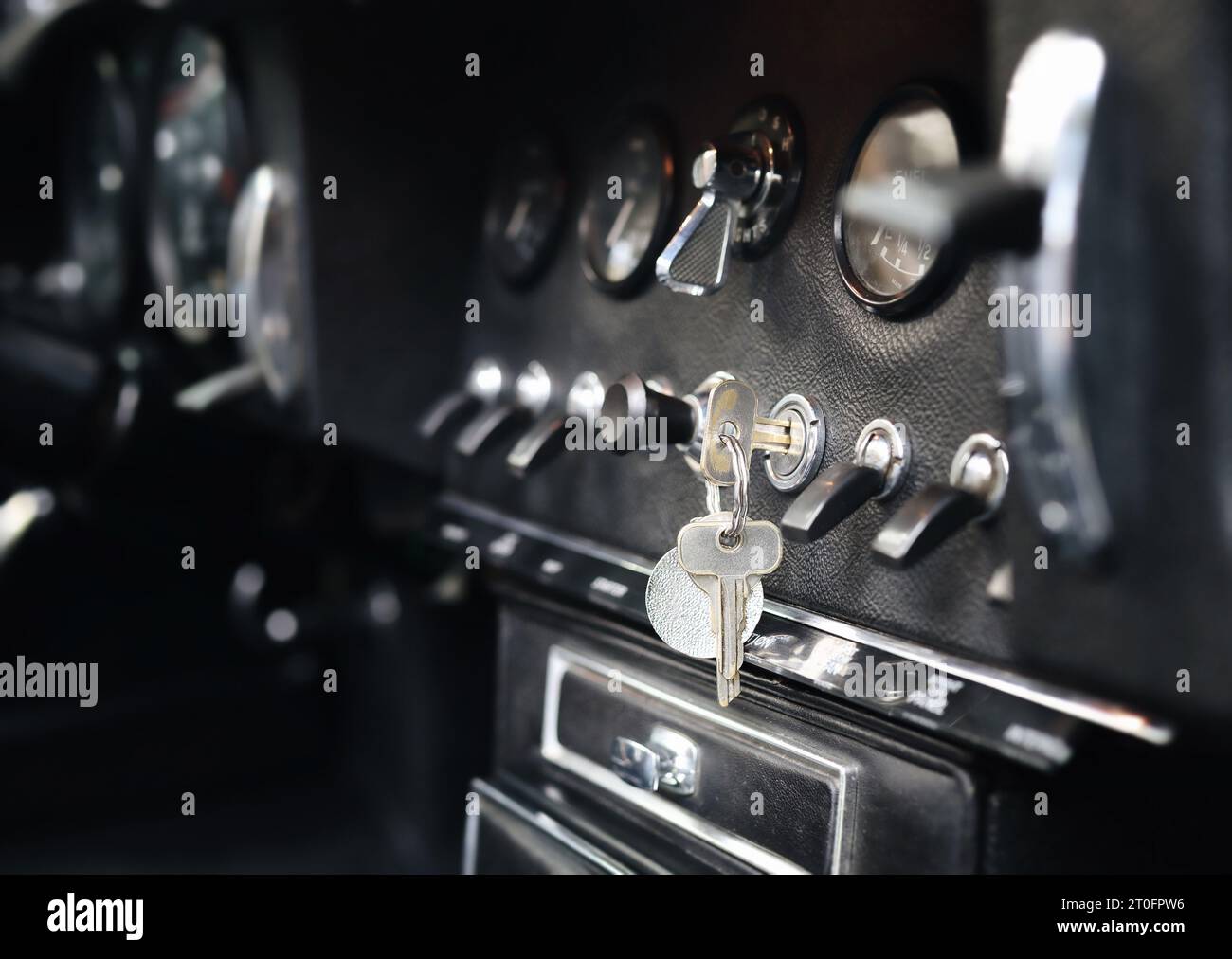 Vintage car dashboard or cockpit with key in ignition. Classic or