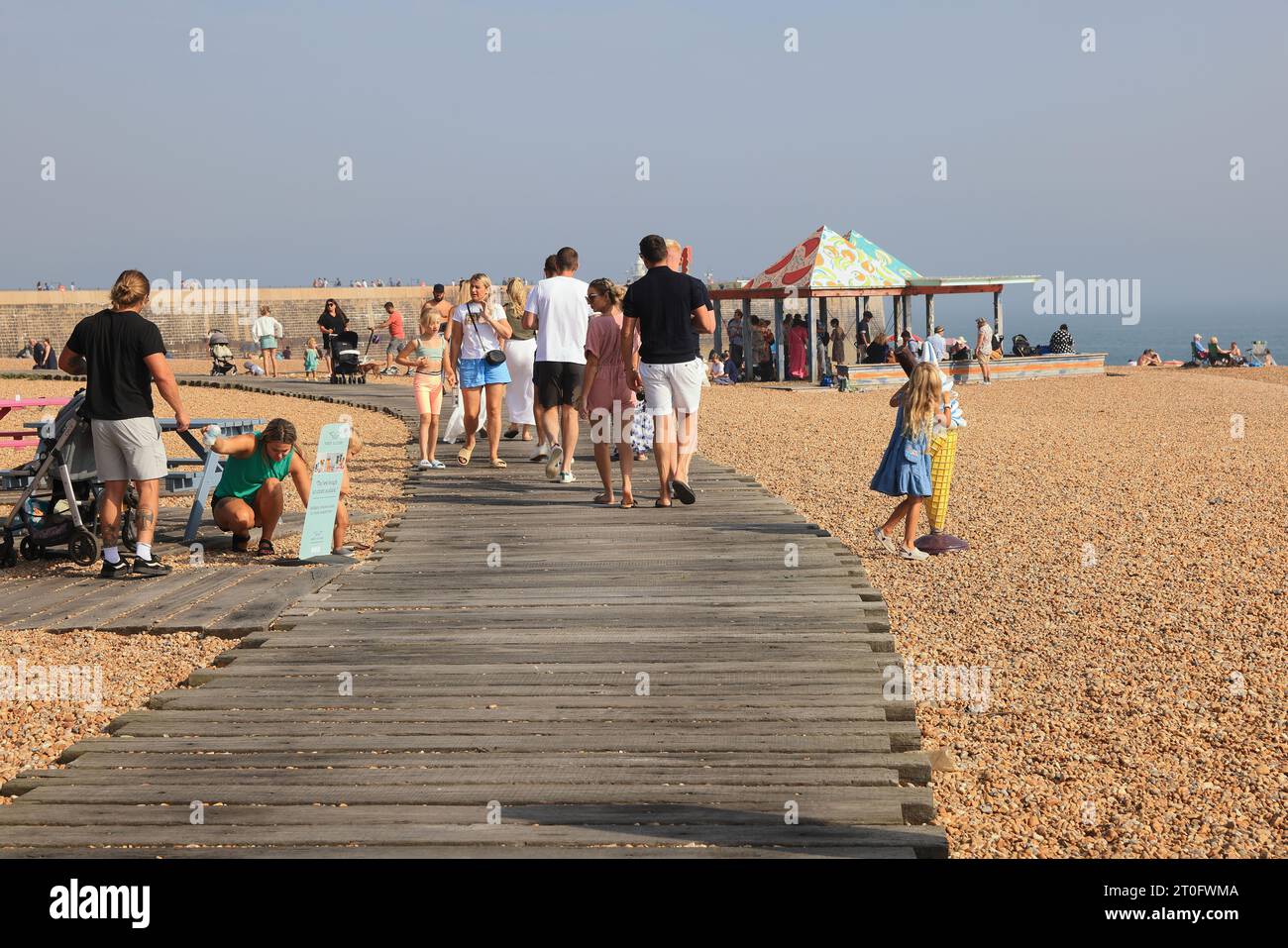 The boardwalk, using the harbour's heritage, old railway sleepers from the station that stopped at the harbour for the pier, forming a beach path. Stock Photo