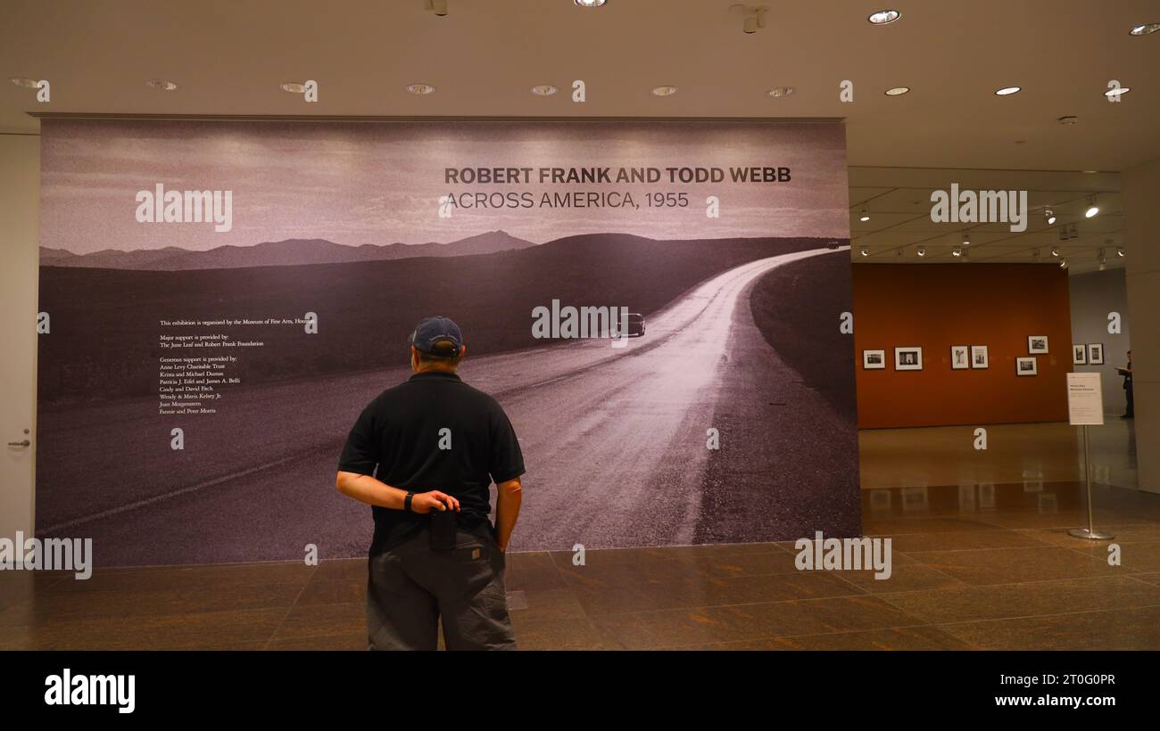 Houston, Oct. 8. 7th Jan, 2024. A man attends the preview of a photo exhibition titled Robert Frank and Todd Webb: Across America, 1955 at the Museum of Fine Arts, Houston, Texas, the United States, on Oct. 6. 2023. A total of 100 photographs chart the cross-country journeys of two photographers, who each captured singular views of America in the mid-20th century, during the exhibition here from Oct. 8, 2023 to Jan. 7, 2024. Credit: Xu Jianmei/Xinhua/Alamy Live News Stock Photo