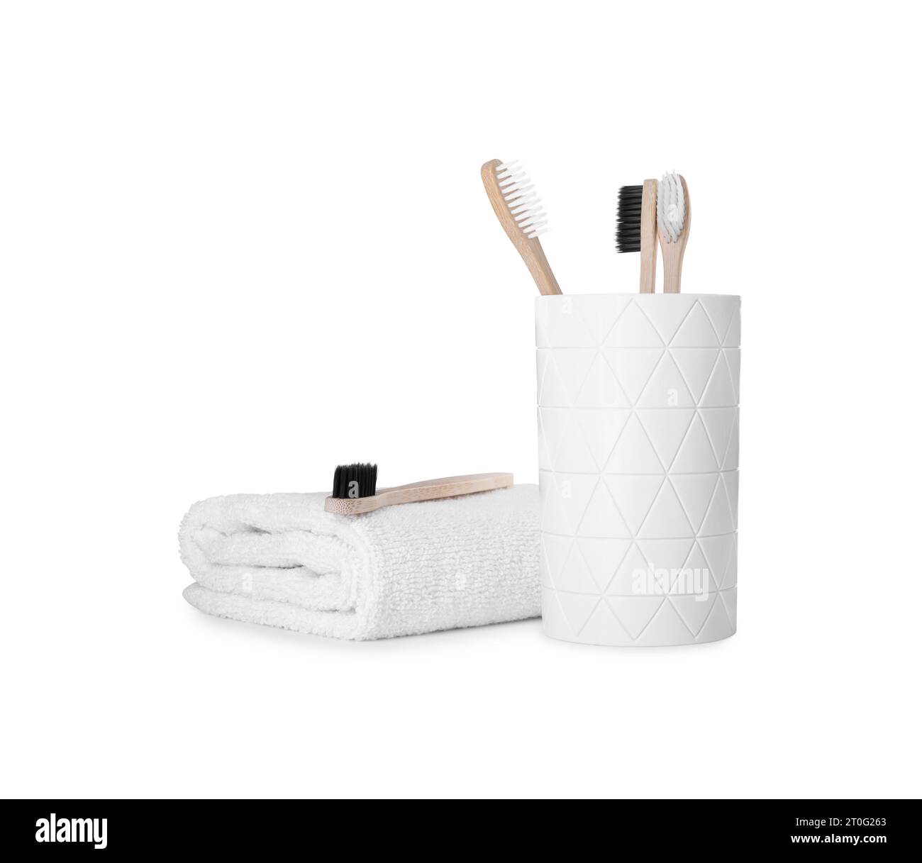 Bamboo toothbrushes and towel isolated on white Stock Photo - Alamy