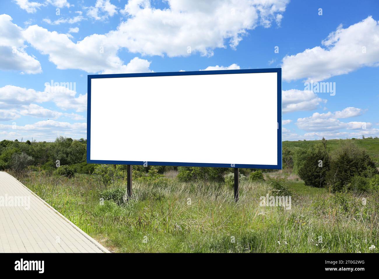 Empty signboard near road outdoors. Mock-up for design Stock Photo - Alamy