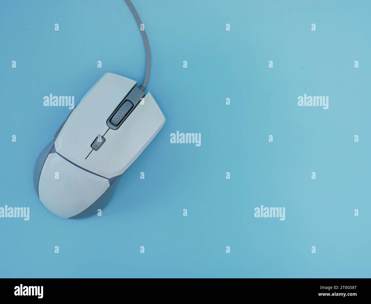 Computer wired gaming mouse white Isolated on a blue background Stock Photo