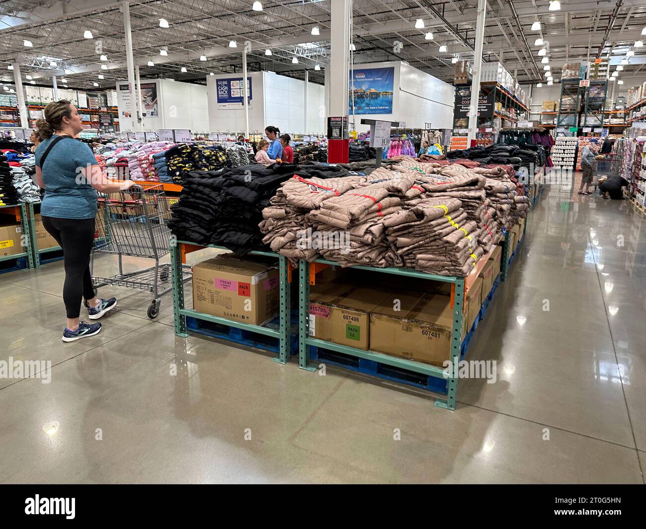 A shopper passes by a display of winter wear on display in a Costco ...