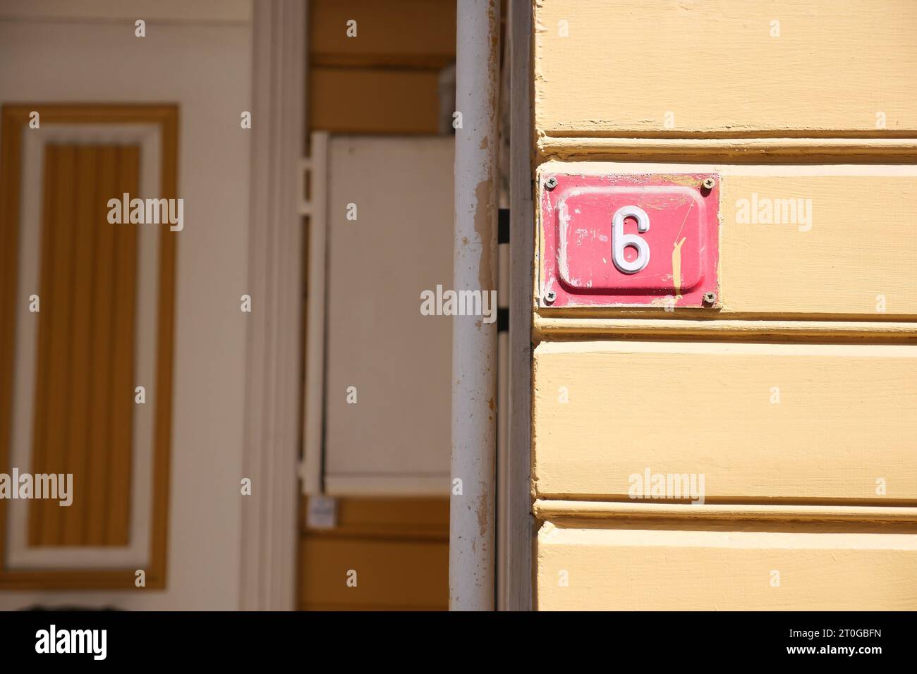 house number six. Decorative lettering on a brick wall Stock Photo Alamy