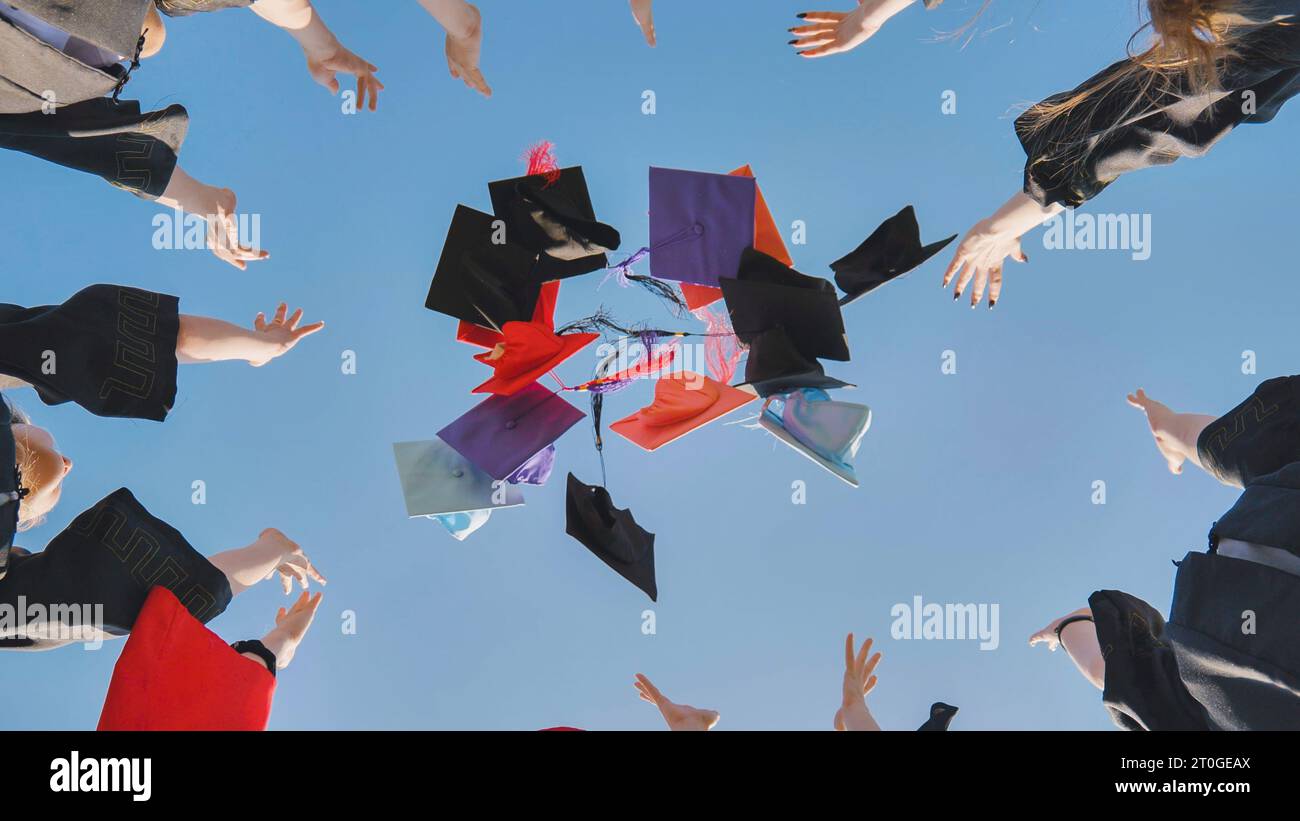 College graduates throw colorful hats up in the air Stock Photo Alamy