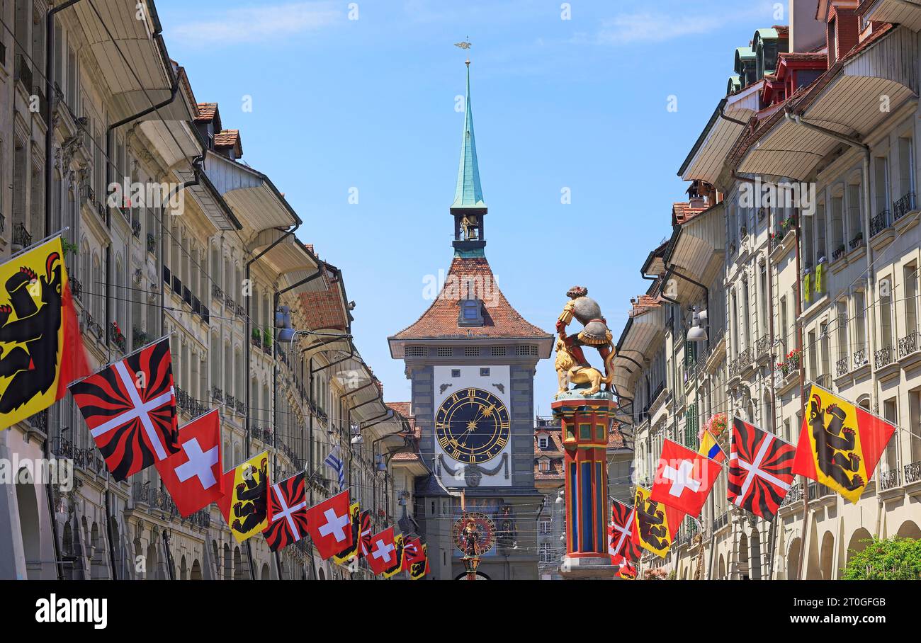 Street view on Kramgasse with fountain and Zytglogge Clock Tower in the old town of Bern city. It is a popular shopping street and medieval city centr Stock Photo