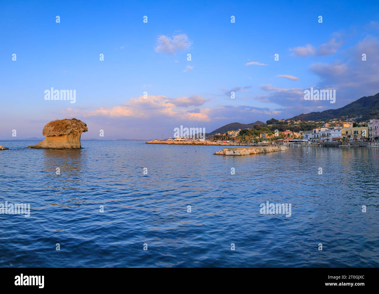 Townscape of Lacco Ameno in Ischia Island. View of the Fungo mushroom rock, a huge block of tuff shaped by the incessant erosion of the sea. Stock Photo
