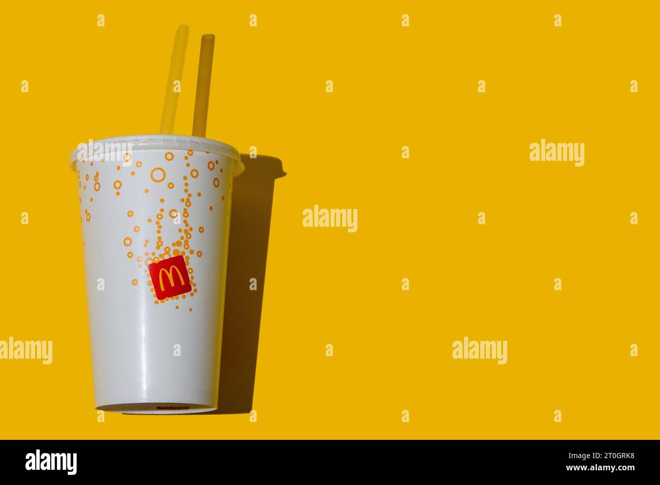 Yellow glass of McDonald's. Paper cup with lid. Takeaway drink ...