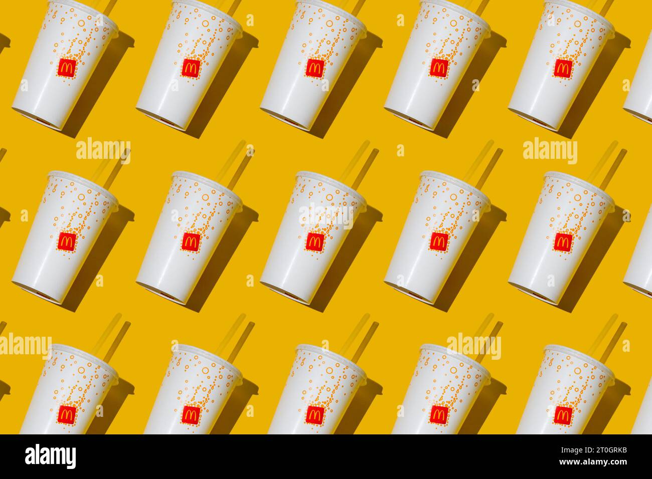 Yellow glass of McDonald's. Paper cup with lid. Takeaway drink ...