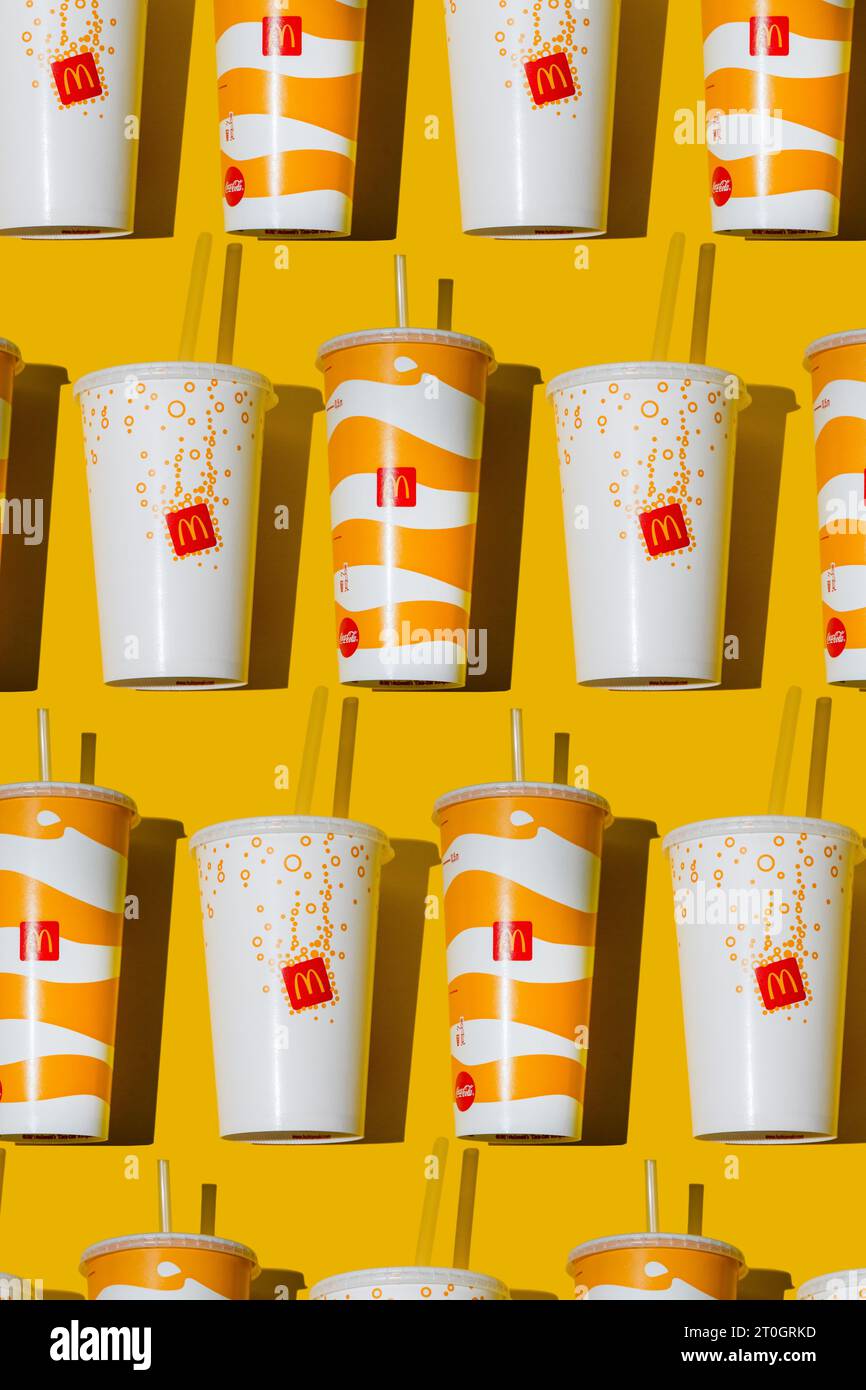 Yellow glass of McDonald's. Paper cup with lid. Takeaway drink ...
