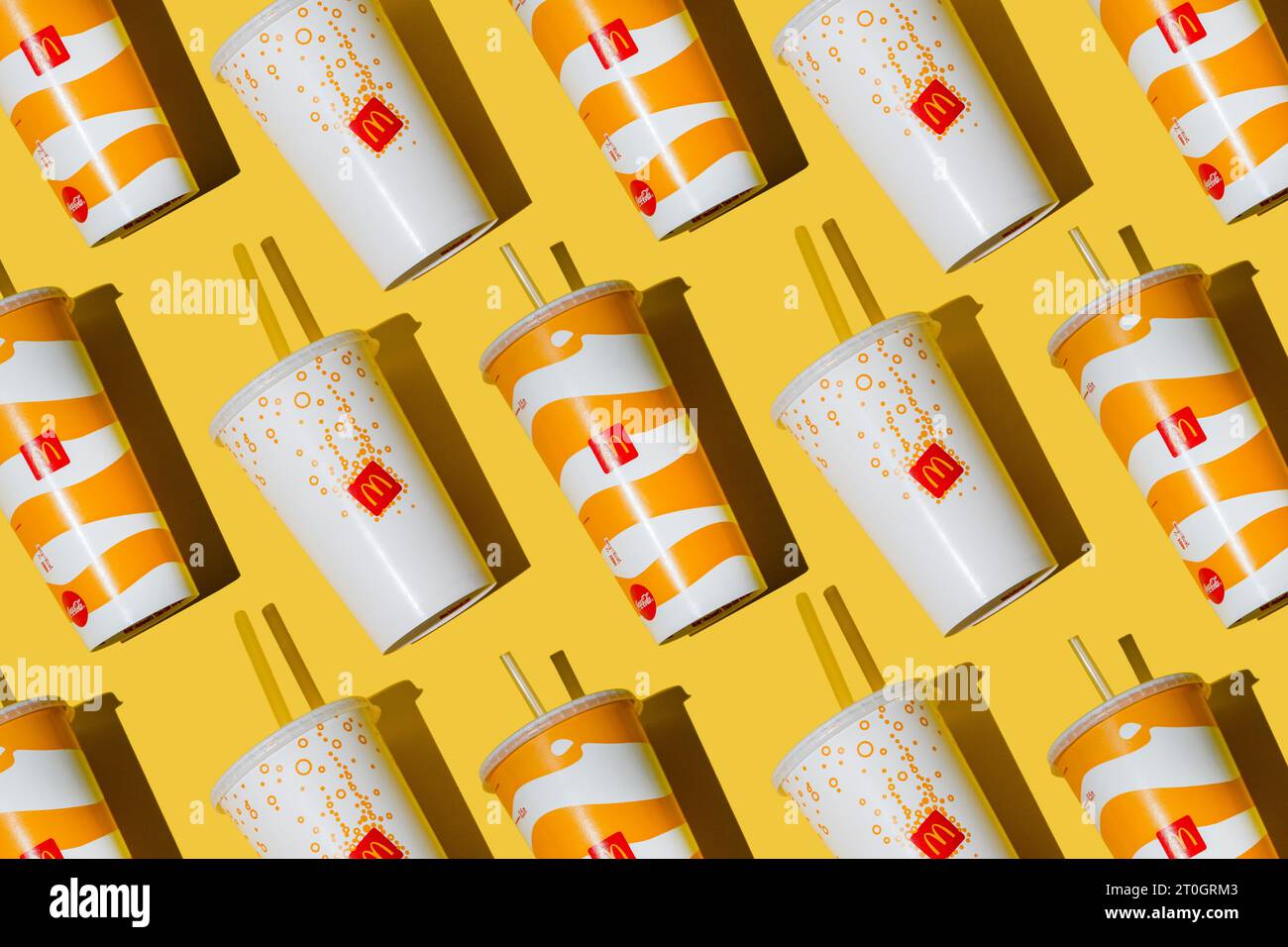 Yellow glass of McDonald's. Paper cup with lid. Takeaway drink ...