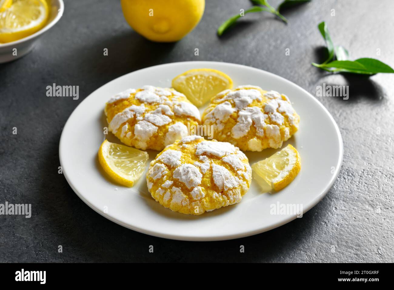 Lemon cookies on plate over dark stone background. Close up view Stock Photo