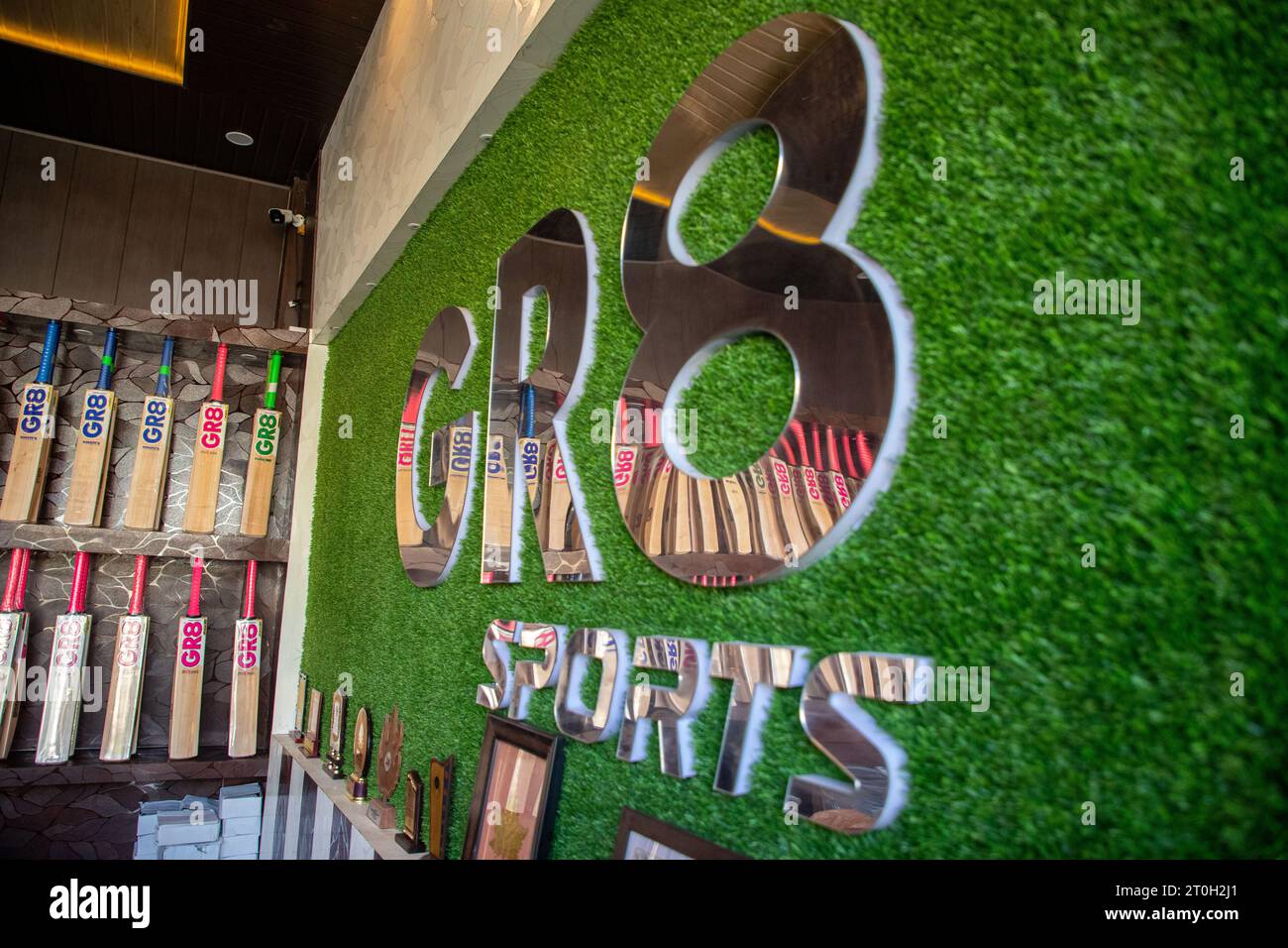 Finished Kashmiri willow wood bats are displayed inside a showroom in