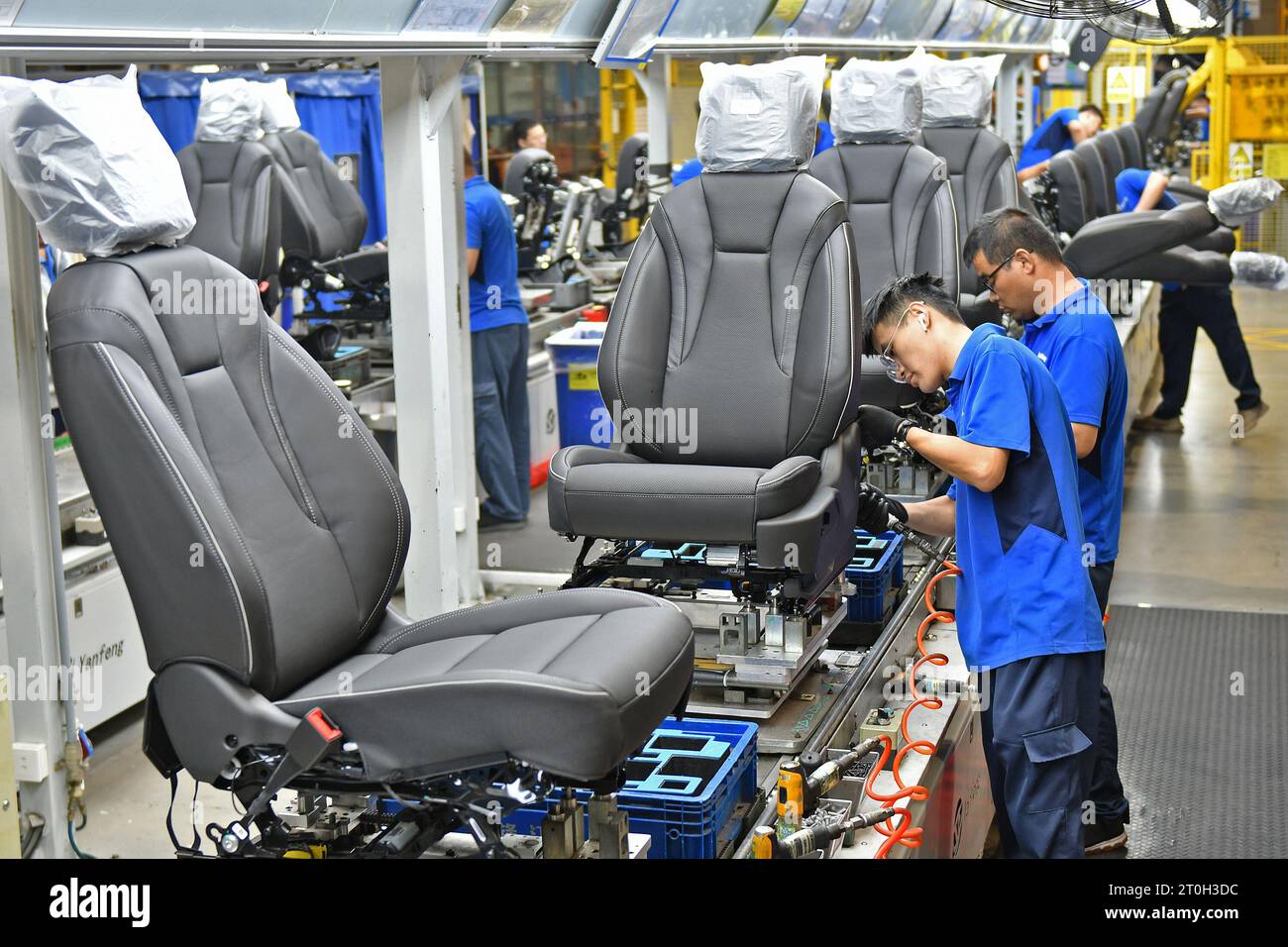 YANTAI, CHINA OCTOBER 7, 2023 Workers assemble car seats on a