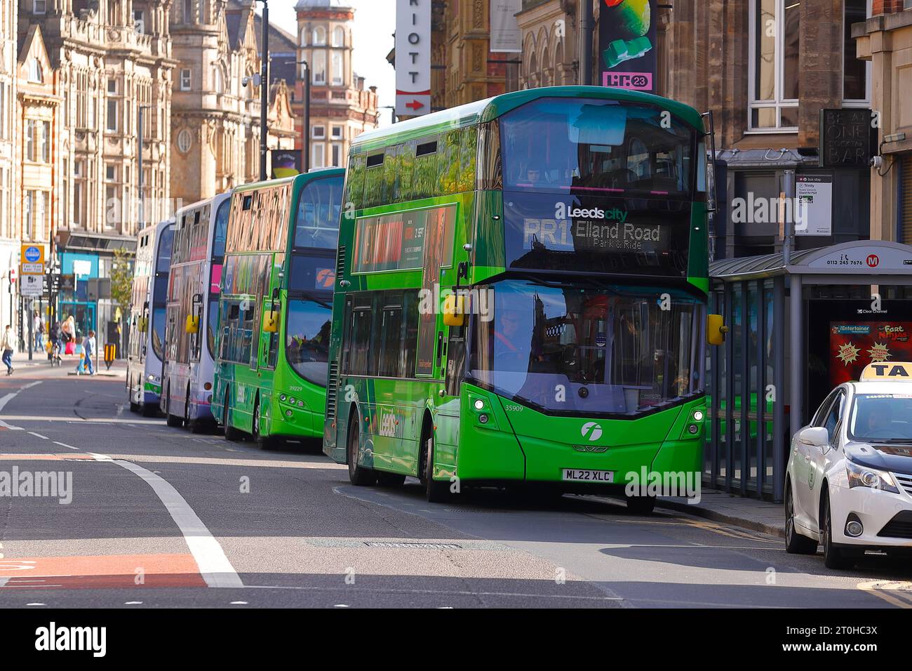 Double decker buses lined up at bus stops on Boar Lane in Leeds City Centre Stock Photo Alamy