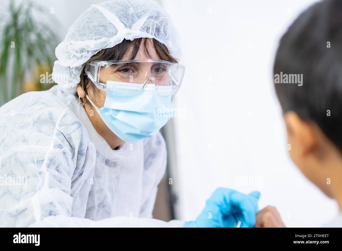 Female doctor bumping a child after the vaccine. Vaccination of children. Immunization in the coronavirus pandemic, covid-19 Stock Photo