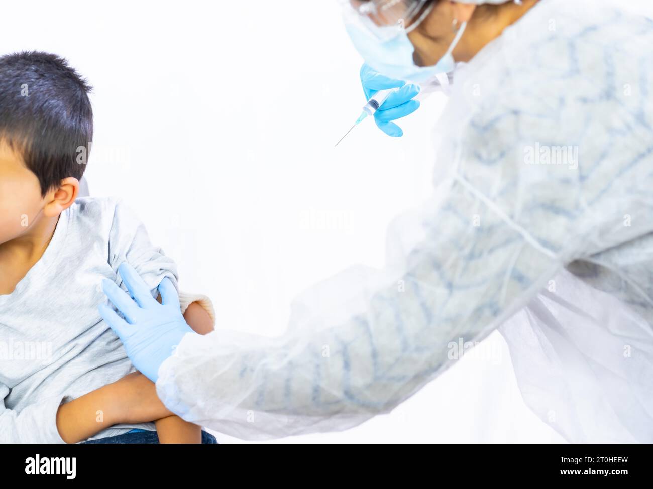 Scared child before vaccine injection. Vaccination of children. Immunization in the coronavirus pandemic, covid-19 Stock Photo