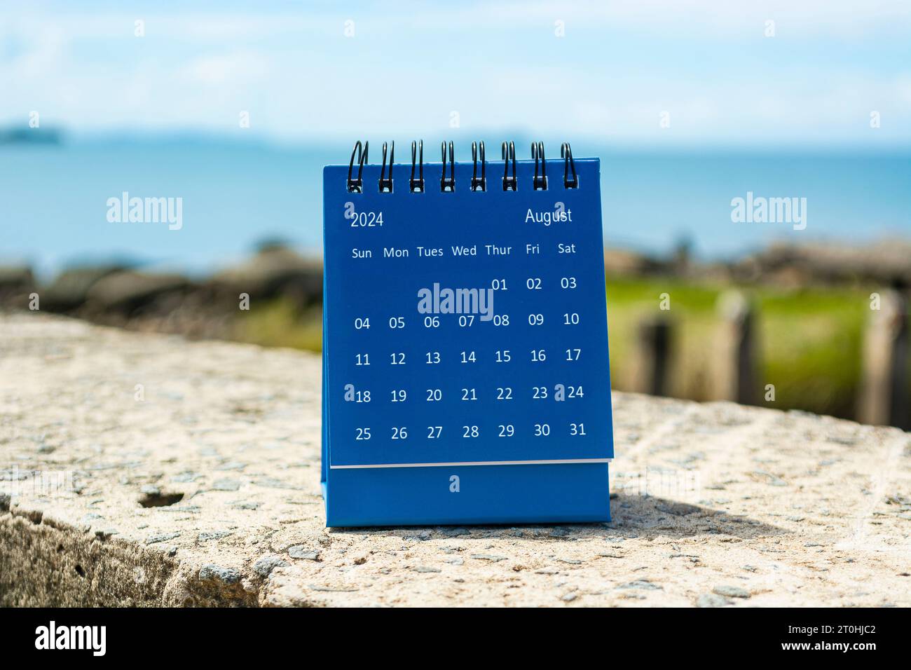 Blue August 2024 calendar on blurred background of blue ocean. 2024 New