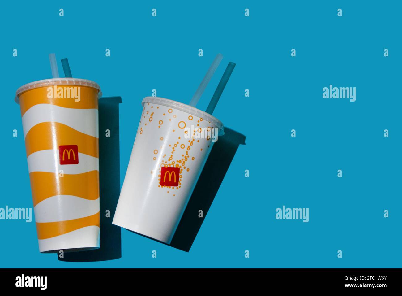 Yellow glass of McDonald's. Paper cup with lid. Takeaway drink ...