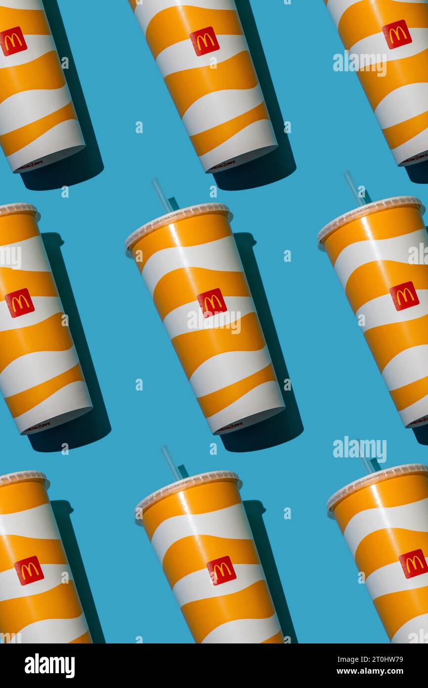 Yellow glass of McDonald's. Paper cup with lid. Takeaway drink ...