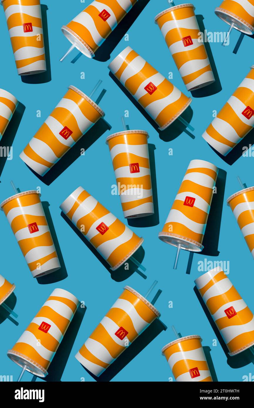 Yellow glass of McDonald's. Paper cup with lid. Takeaway drink ...