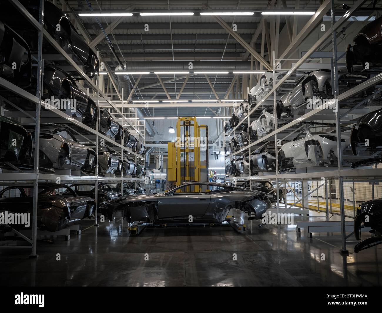 Robots moving Aston Martin body shells into position on the production line at the factory in Gaydon, Warwickshire. Stock Photo