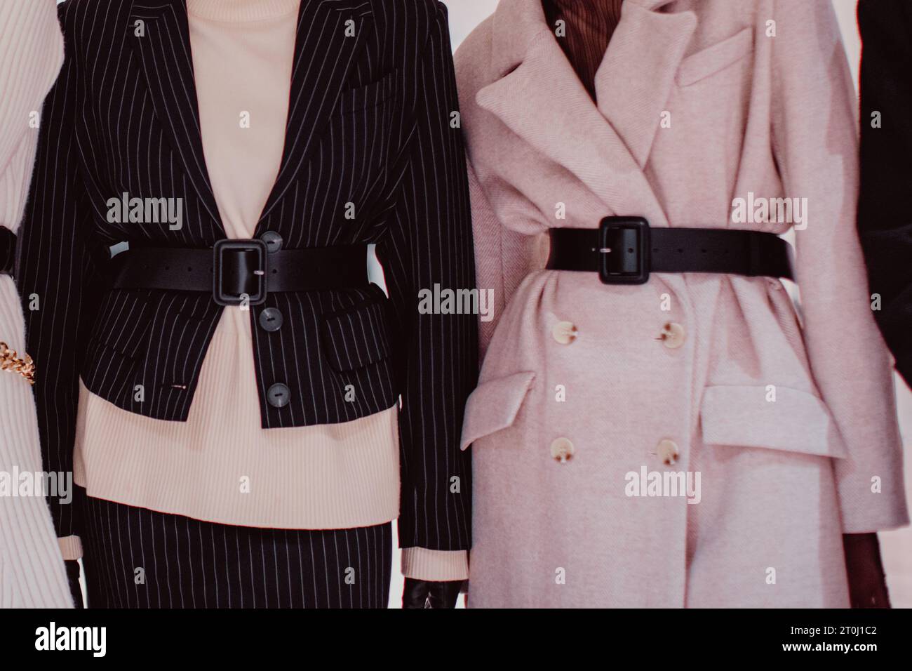 Fashionable details of a black striped classic blazer and a warm belted long coat. Women's fashion and stylish accessories Stock Photo