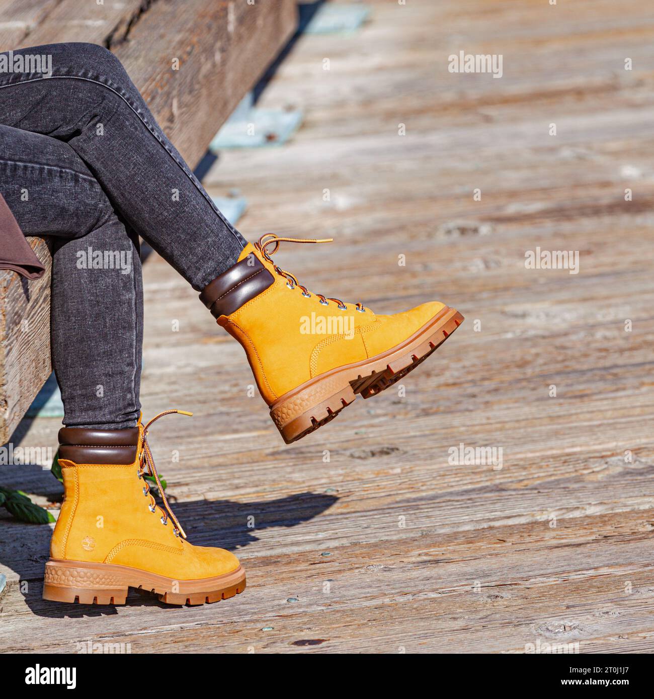 Young woman wearing new boots for the autumn season in Steveston Stock Photo