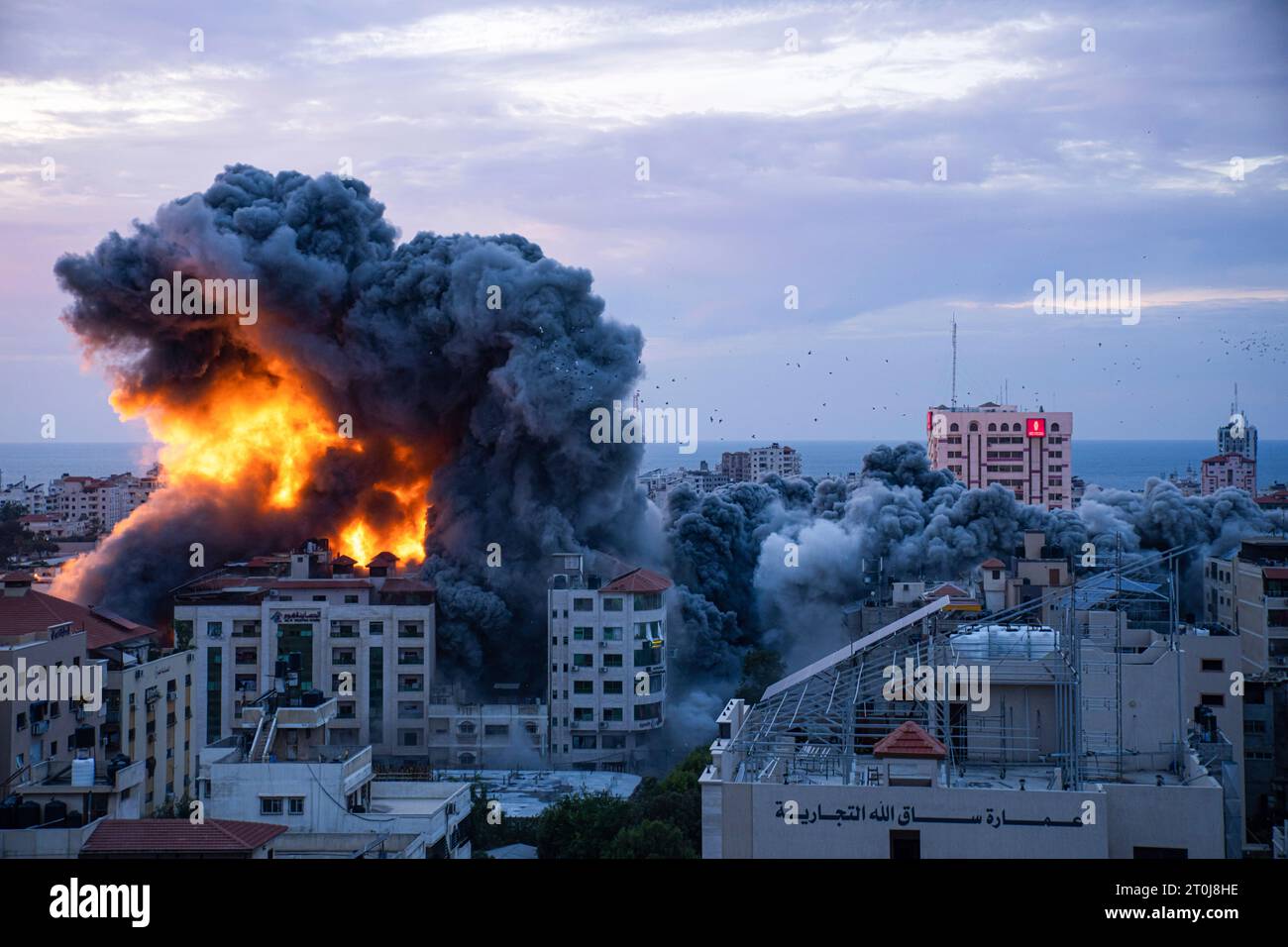 Fire and smoke rises following an Israeli airstrike, in Gaza City, Saturday, Oct. 7, 2023. The militant Hamas rulers of the Gaza Strip carried out an unprecedented, multi-front attack on Israel at daybreak Saturday, firing thousands of rockets as dozens of Hamas fighters infiltrated the heavily fortified border in several locations by air, land, and sea, killing dozens and stunning the country. Palestinian health officials reported scores of deaths from Israeli airstrikes in Gaza. (AP Photo/Fatima Shbair) Stock Photo