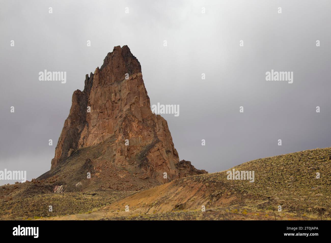 Agathla Peak, an eroded volcanic plug considered sacred by the Navajo, near Monument Valley, AZ Stock Photo
