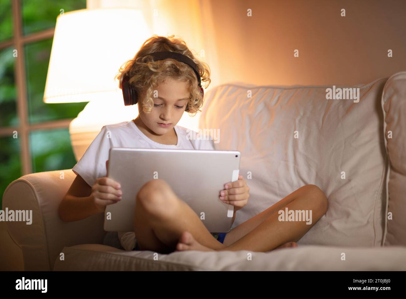 Very happy child playing game online with laptop stay at home. Asian boy  student online learning class study online video call teacher Stock Photo -  Alamy