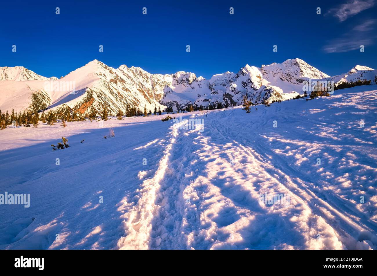Beautiful winter landscape in the Polish mountains. Snowy trail leading to the Gasienicowa valley in National Park in the Tatra Mountains, Poland. Stock Photo