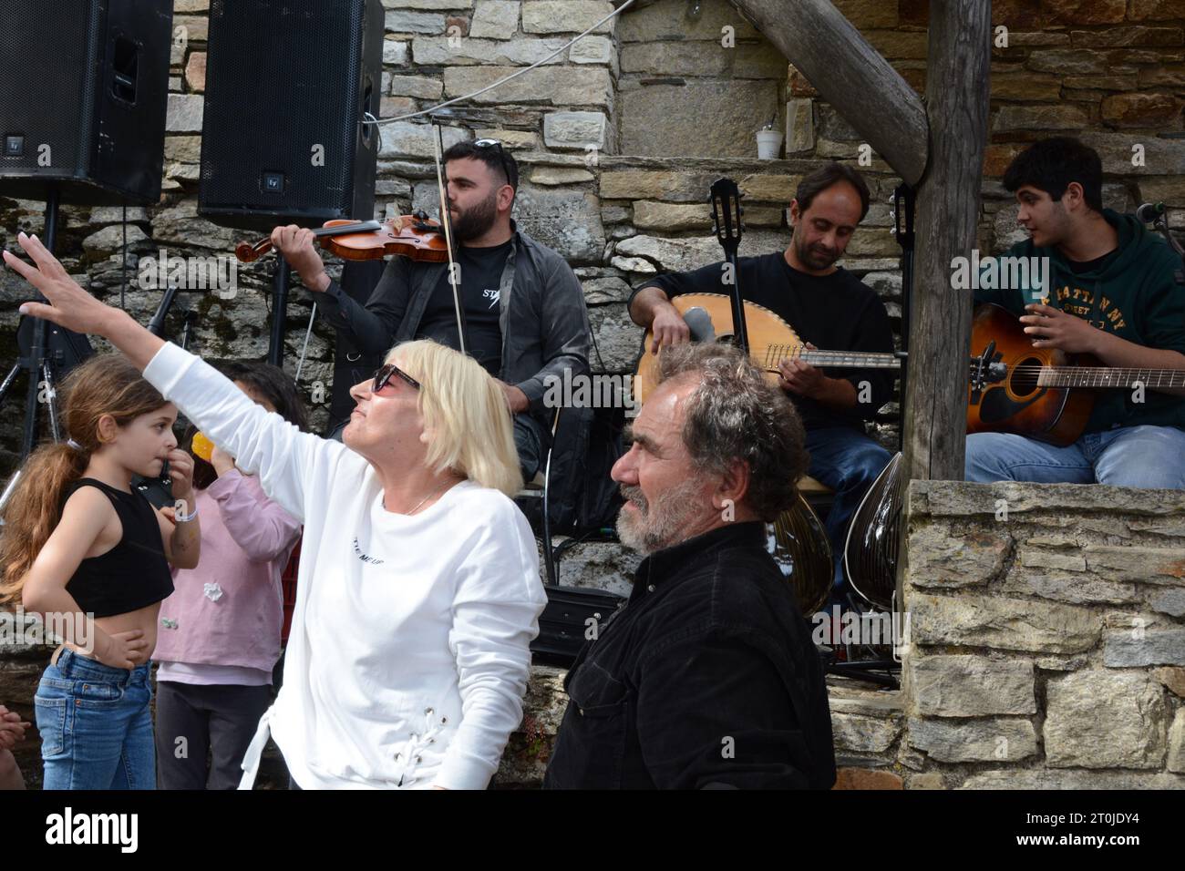Greek villagers and musicians in a 'blue zone' at the panigiri village festival of Agios Isidoros (Saint Isidore), near Pezi, Ikaria island, Greece. Stock Photo