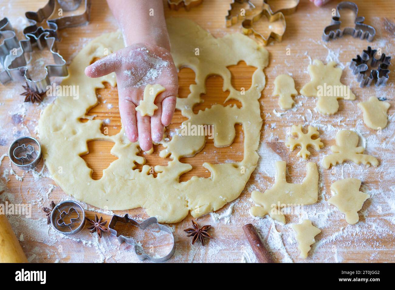 11 August 2023: Kids hand with cookie cutter and cookie dough, Christmas baking concept *** Kinderhand mit Ausstechform und Plätzchenteig, Backen zu Weihnachten Konzept Credit: Imago/Alamy Live News Stock Photo