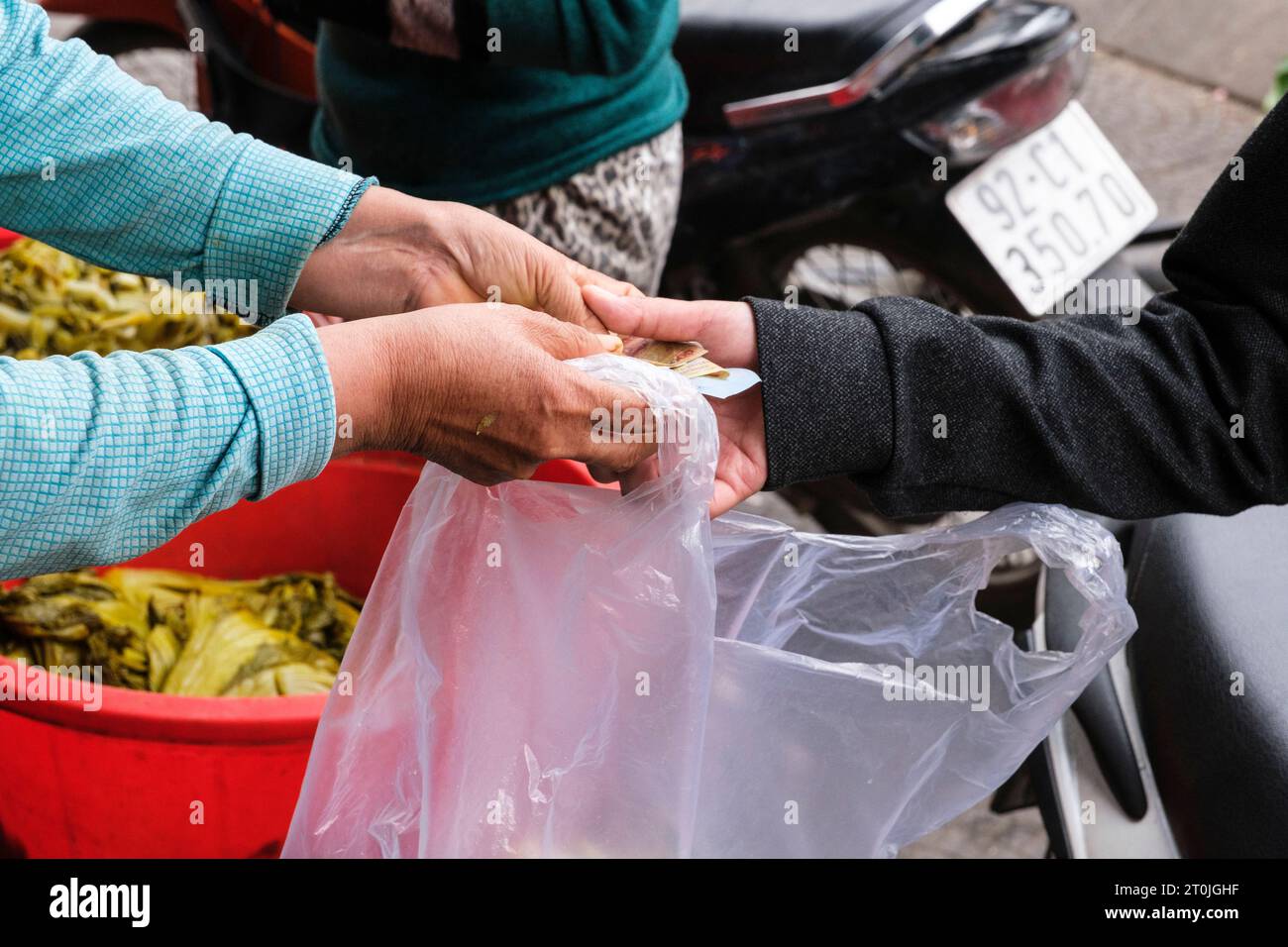 Hoi An, Vietnam. Completing a Purchase in the Market. Stock Photo