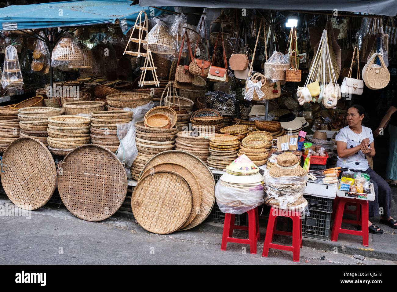 Hoi An, Vietnam. Vendor of Baskets and Trays in the Market. Stock Photo