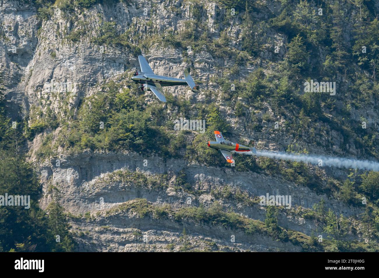 Mollis, Switzerland, August 18, 2023 Lockheed Model 12 Electra Junior and a Pilatus P-3-05 aircraft in formation flight during an air show Stock Photo