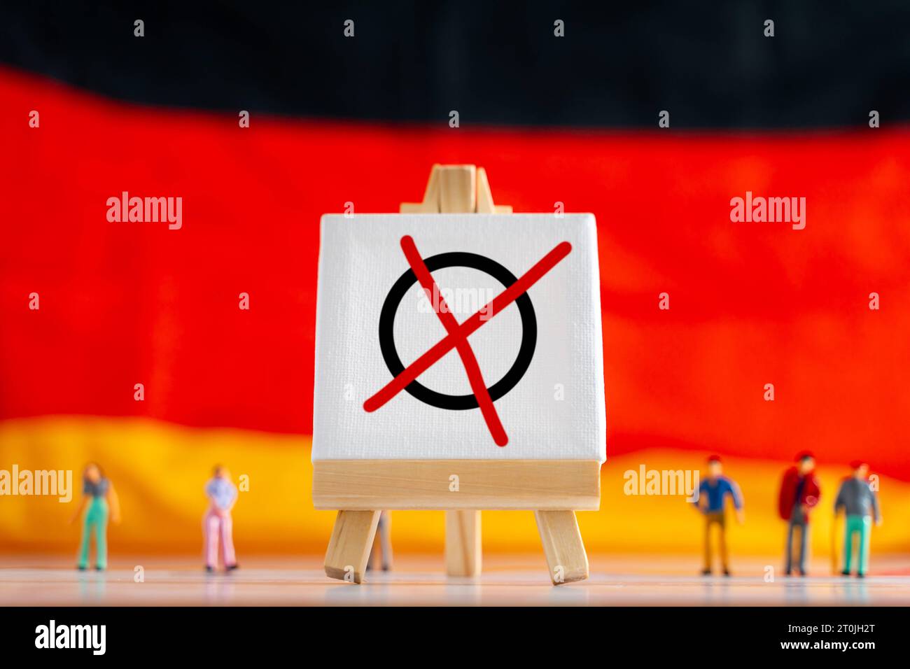 Augsburg, Bavaria, Germany. 7th Oct, 2023. Germany flag with miniature people and a canvas with election cross, Germany votes, politics and election concept PHOTOMONTAGE *** Deutschlandflagge mit Miniatur Menschen und einer Leinwand mit Wahl Kreuz, Deutschland Wählt, Politik und Wahl Konzept FOTOMONTAGE Credit: Imago/Alamy Live News Stock Photo
