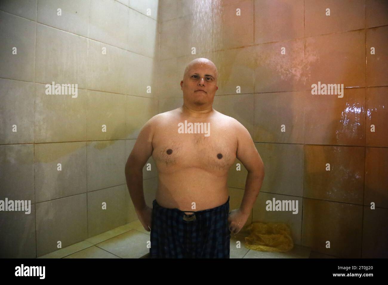 Sarein, Ardabil, Iran. 5th Oct, 2023. An Iranian man with Down syndrome takes showers at the Gavmish Goli natural hot spring in the city of Sarein, known as one of the most famous tourist attractions of Ardabil province. Sarein Hot Springs is a natural haven renowned for its therapeutic waters. Nestled amidst the stunning beauty of the Alborz Mountains, these hot springs offer visitors a rejuvenating experience. The mineral-rich waters, known for their healing properties, flow from the volcanic Sabalan Mountain. (Credit Image: © Rouzbeh Fouladi/ZUMA Press Wire) EDITORIAL USAGE ONLY! Not for Stock Photo