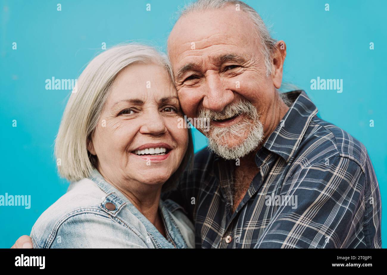Happy Latin senior couple smiling into the camera - Elderly people and love relationship concept Stock Photo