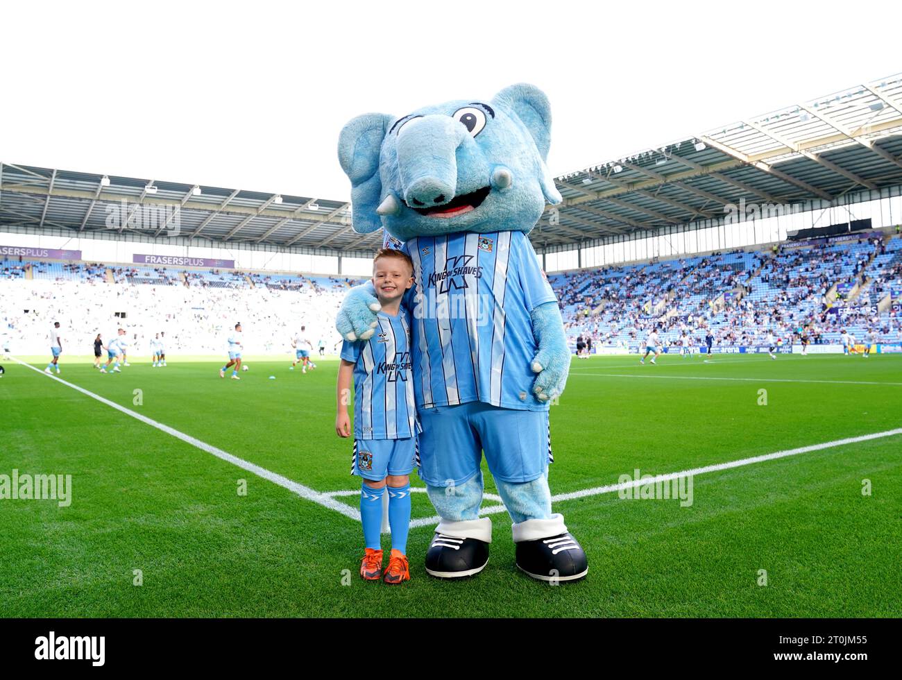 A Coventry City match day mascot poses for a photo with Sky Blue Sam