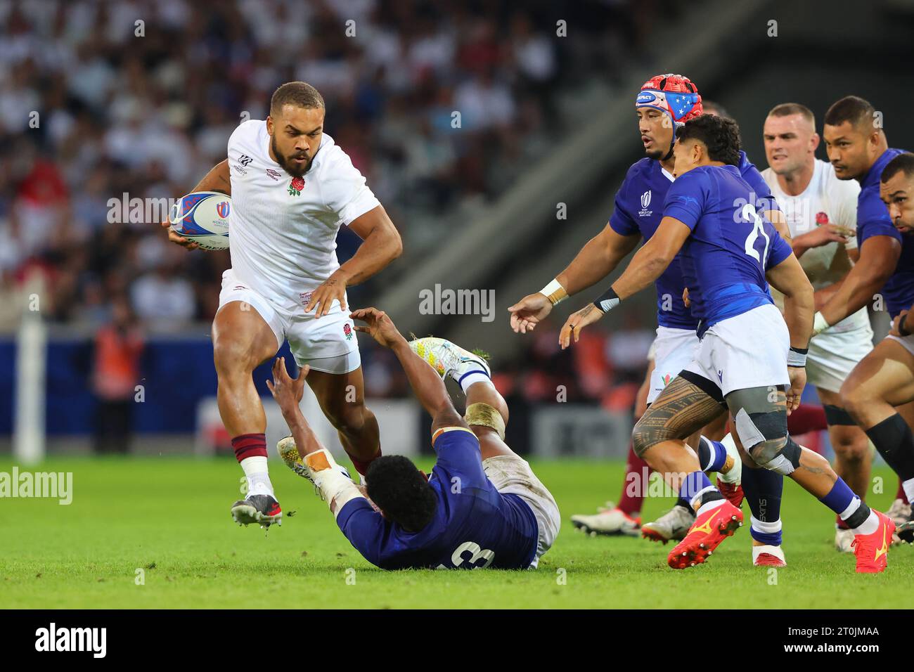 Lille, France. 7th Oct, 2023. Ollie Lawrence (L) of England breaks the tackle of Samoa's Tumua Manu (ground) during the Rugby World Cup 2023 match at Stade Pierre Mauroy, Lille. Picture credit should read: Paul Thomas/Sportimage Credit: Sportimage Ltd/Alamy Live News Stock Photo