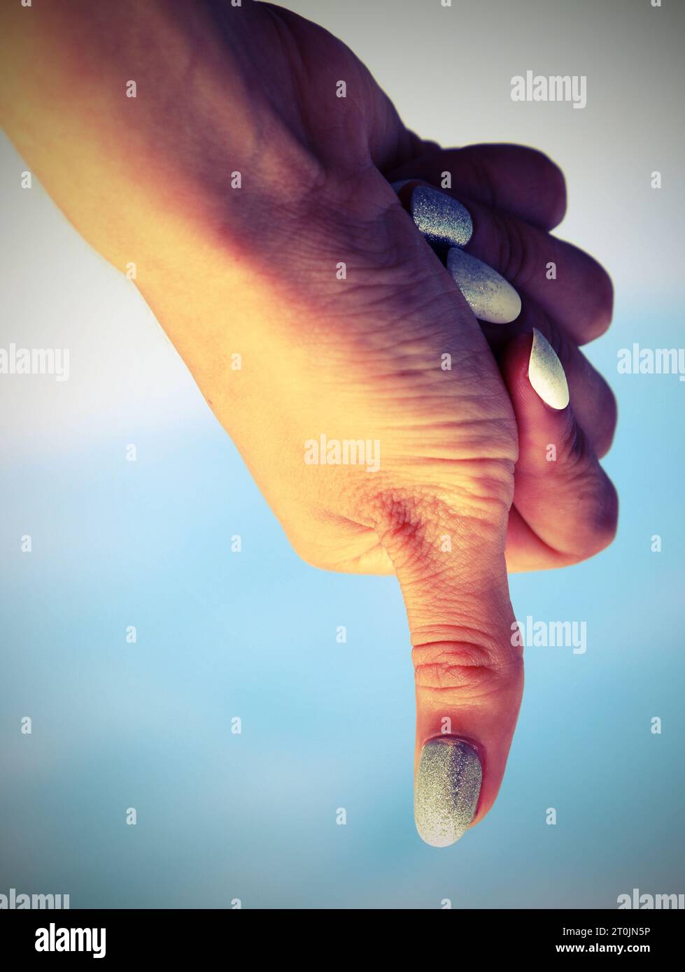 hand of girl making thumbs down sign Meaning failure with antiqued ...